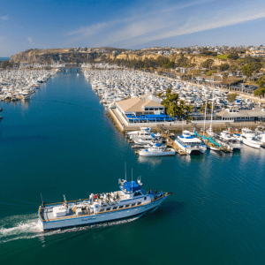 a harbor filled with lots of small boats in a large body of water