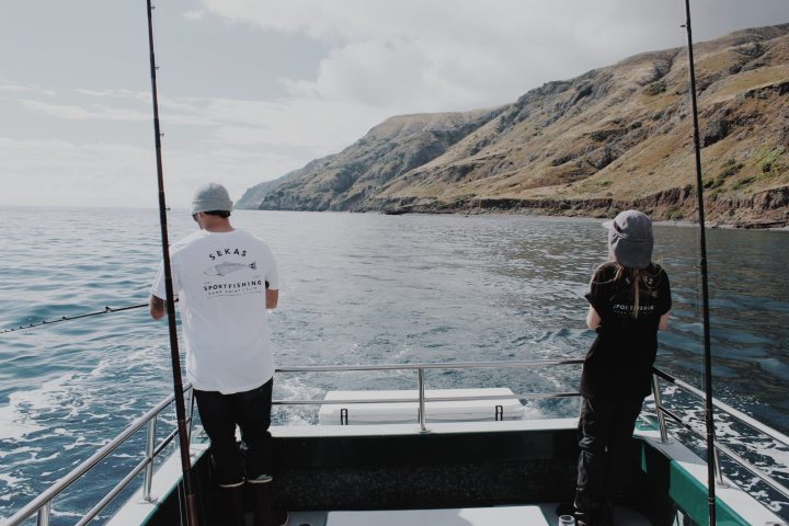 a man standing next to a body of water
