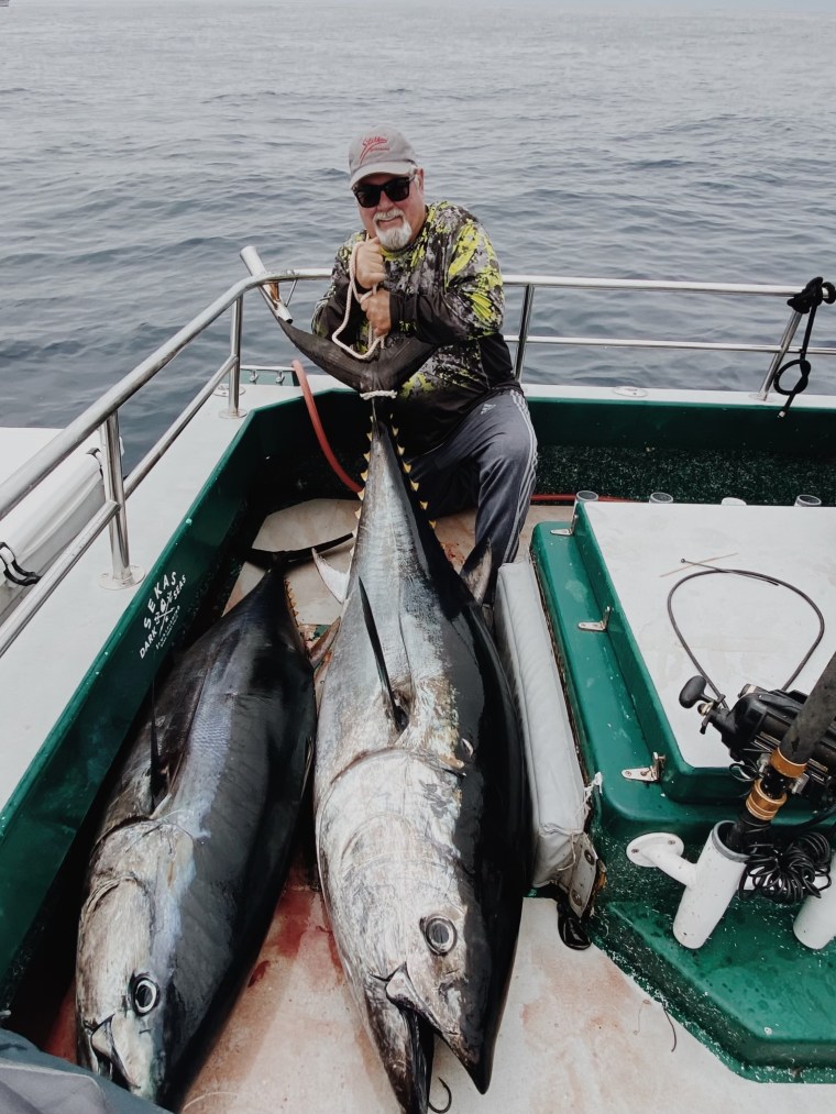 Angler with tuna on the deck of the Lex Sea
