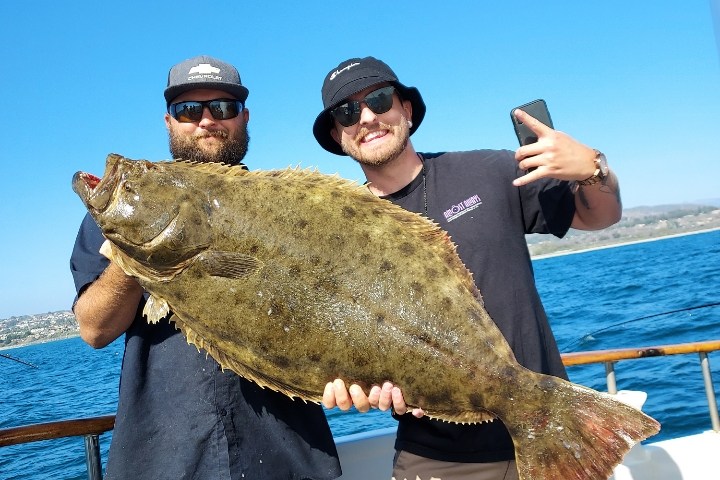 a person standing next to a body of water
