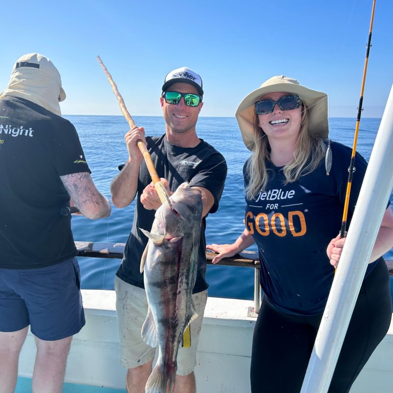 a person holding a fish in the water
