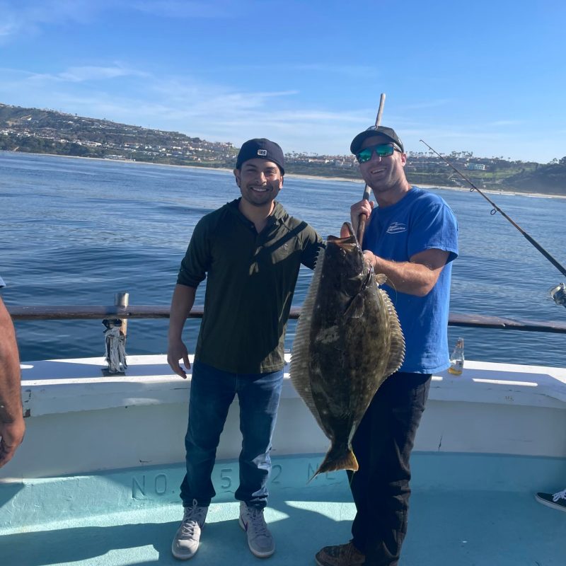 a man holding a fish in the water