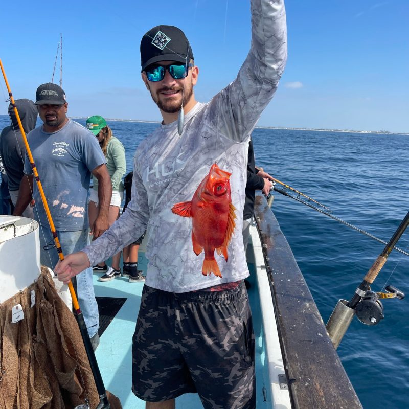 a man holding a pair of people on a boat