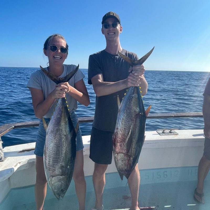 a person holding a fish in the water