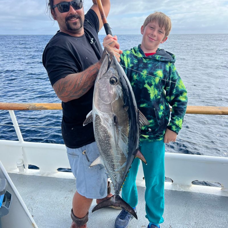 a person holding a fish in the water