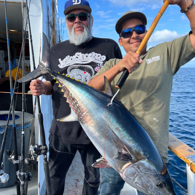 a man holding a fish in the water