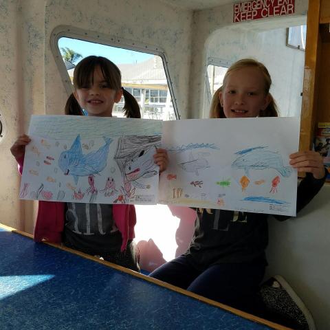 a group of people looking at a laptop