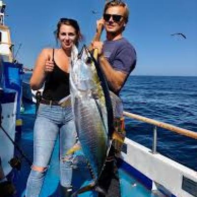 a person holding a fish on a boat