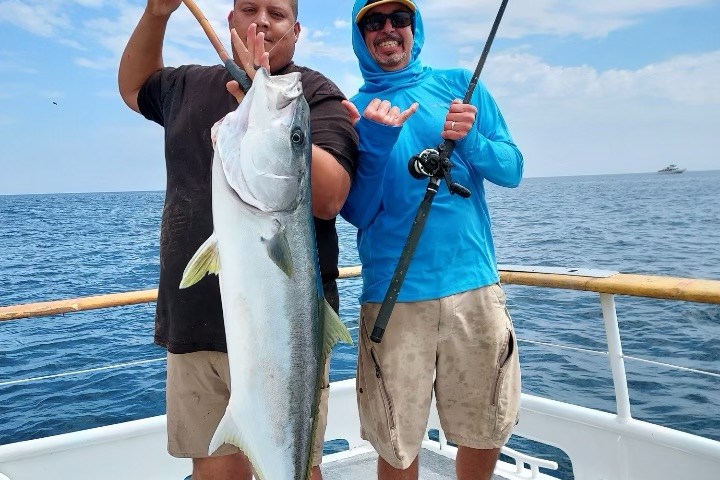 a person holding a fish in the water