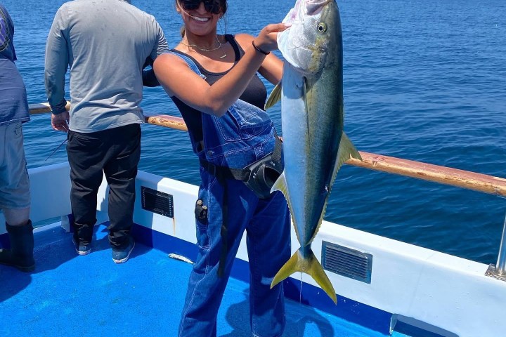 a person holding a fish in the water