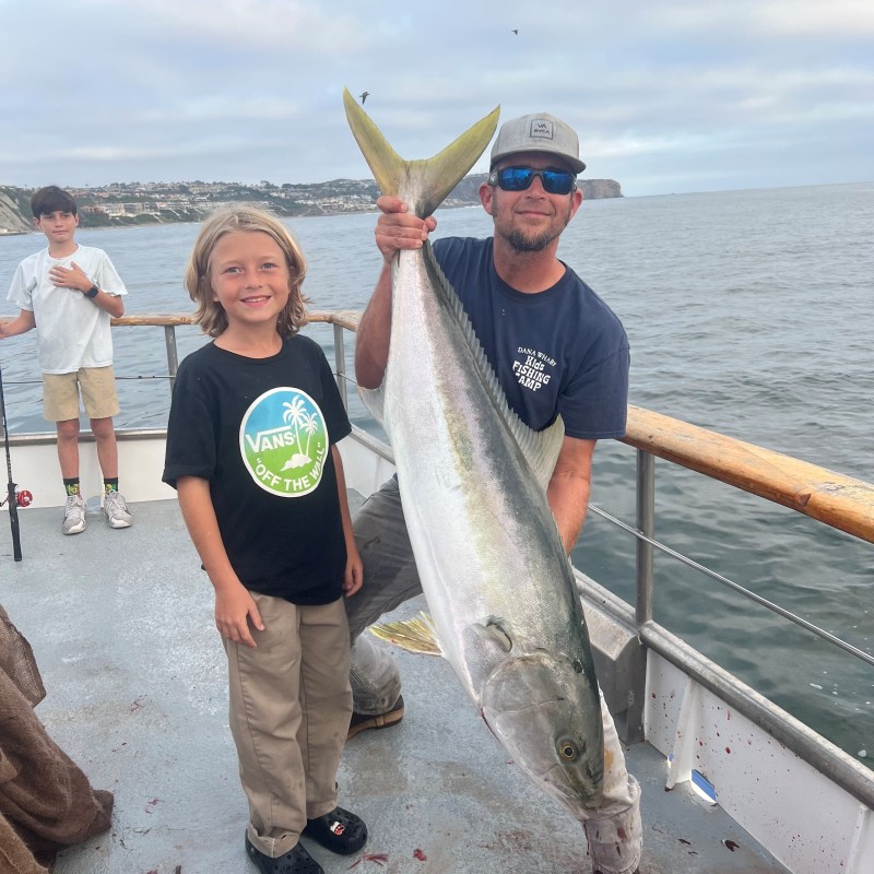 a man holding a fish in the water