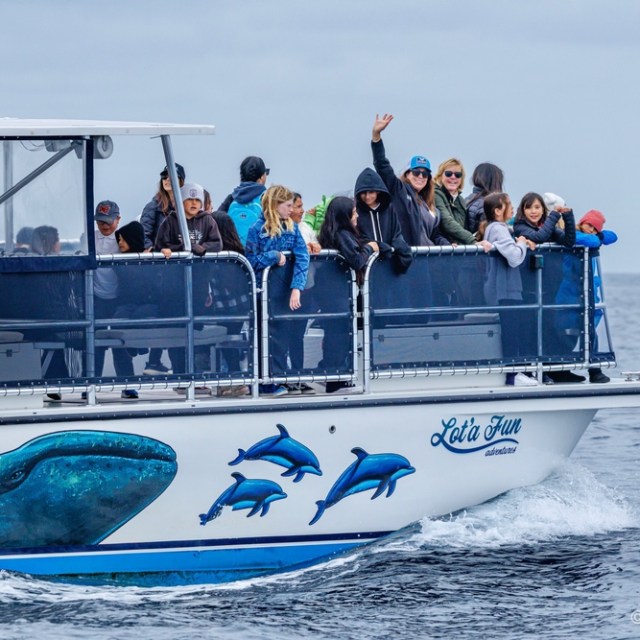 a group of people riding on the back of a boat
