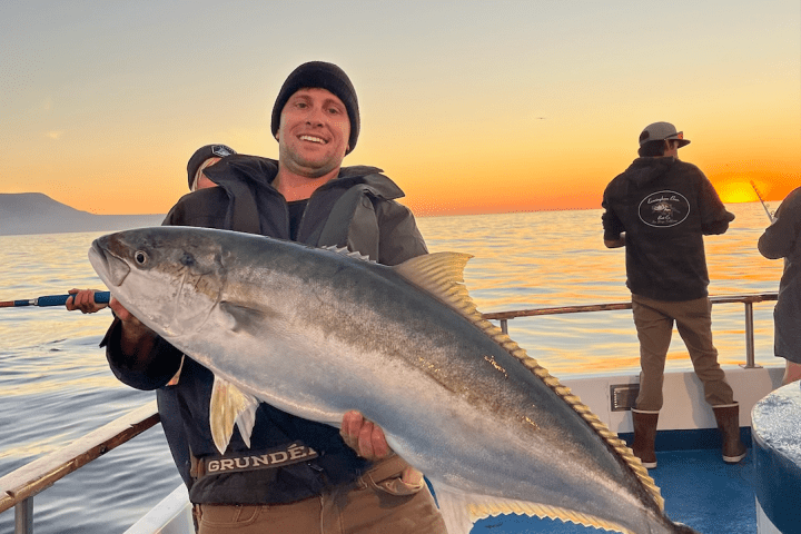 a person holding a fish in the water
