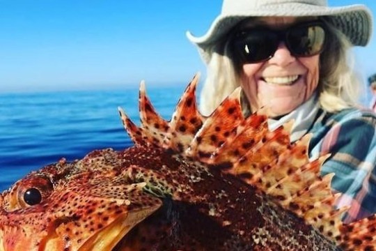 a close up of a person wearing a hat and sunglasses