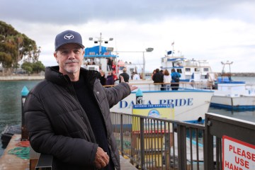 Robert Wyland standing next to a dock