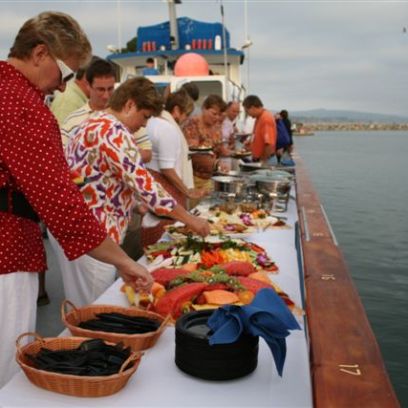a group of people preparing food on a table