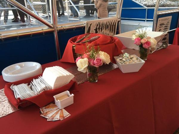 a person sitting at a table with a red flower