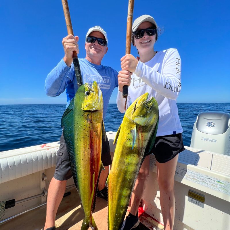 a person holding a fish on a boat