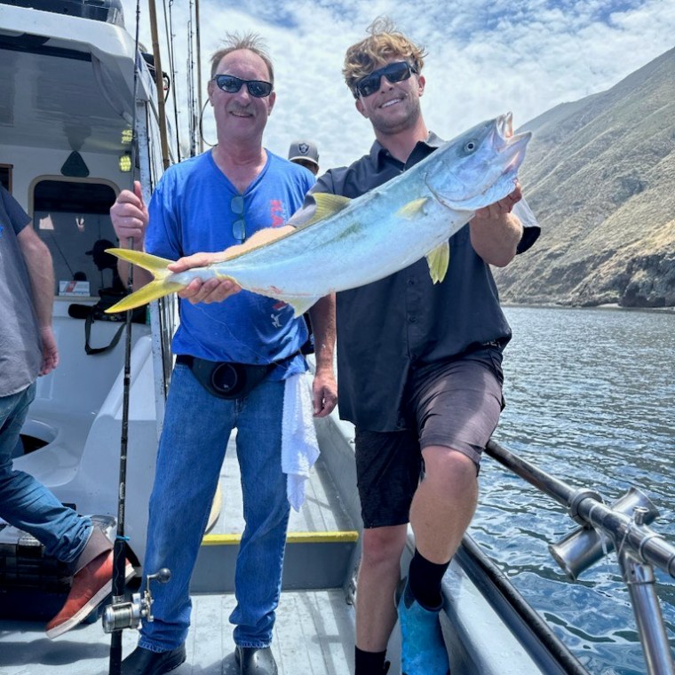 a group of people standing on a boat