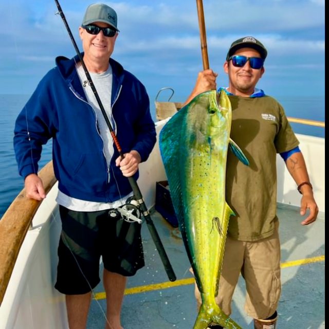 a person holding a fish in the water