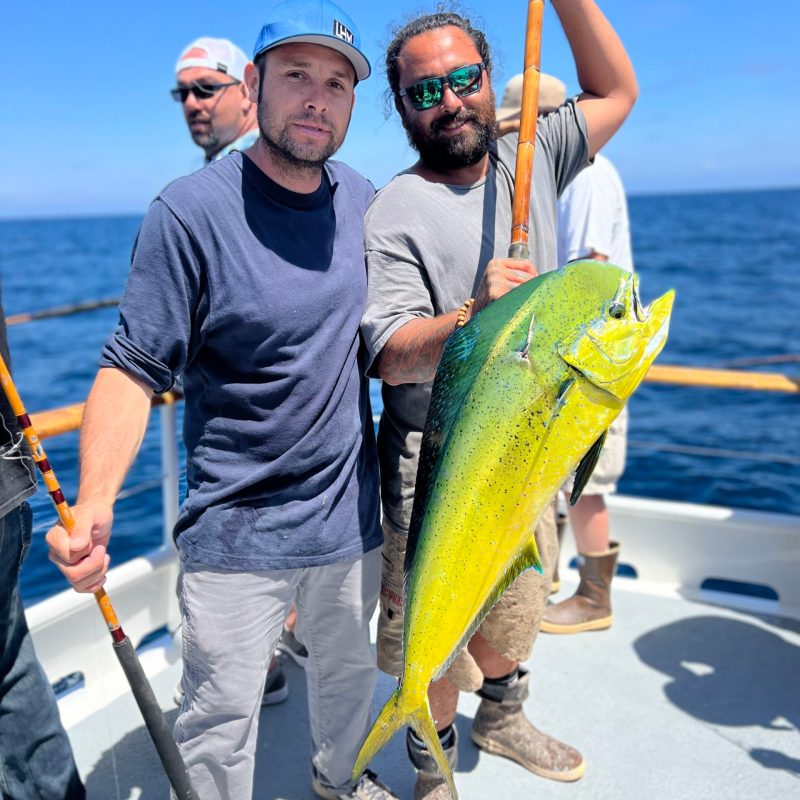 a man holding a fish in the water