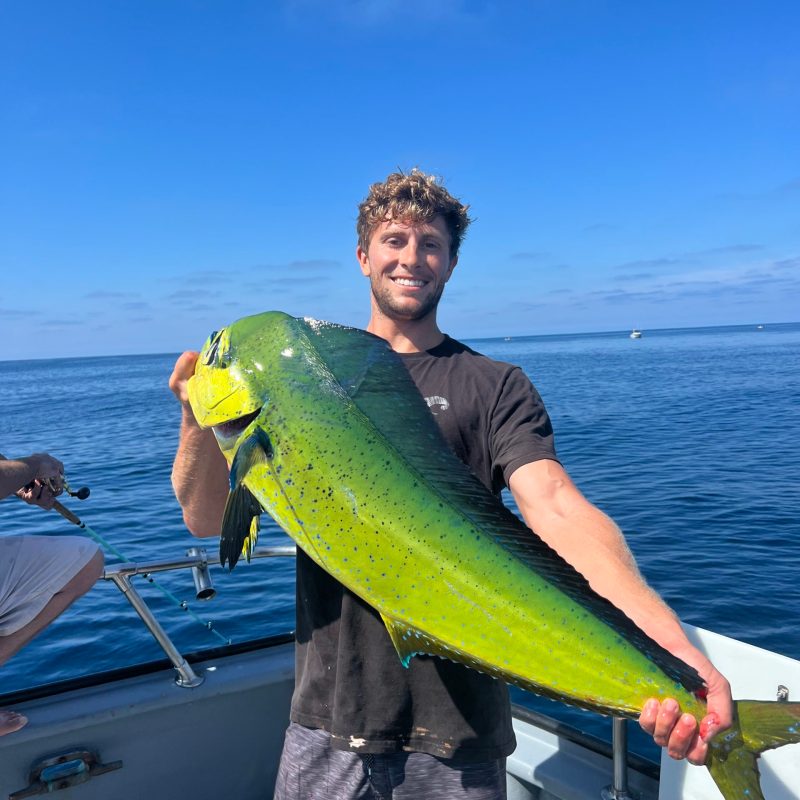 a man standing next to a body of water