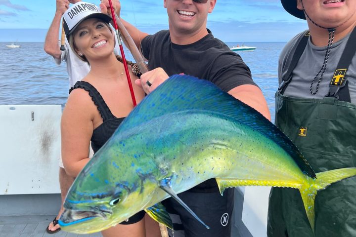 a person holding a fish in the water