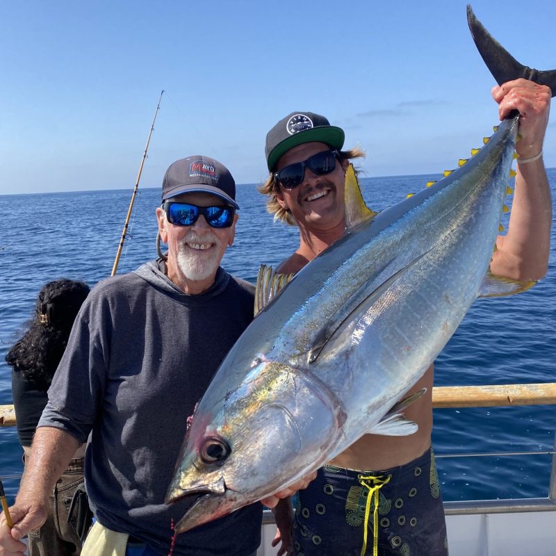 a person holding a fish in the water