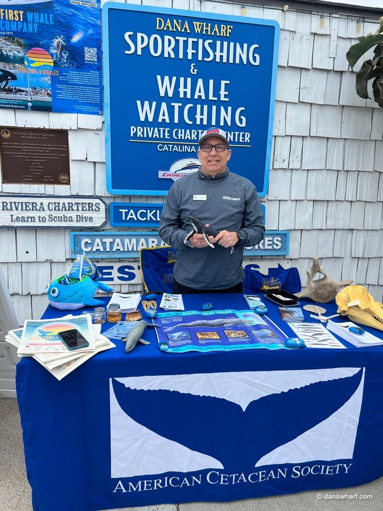 a man standing in front of a sign