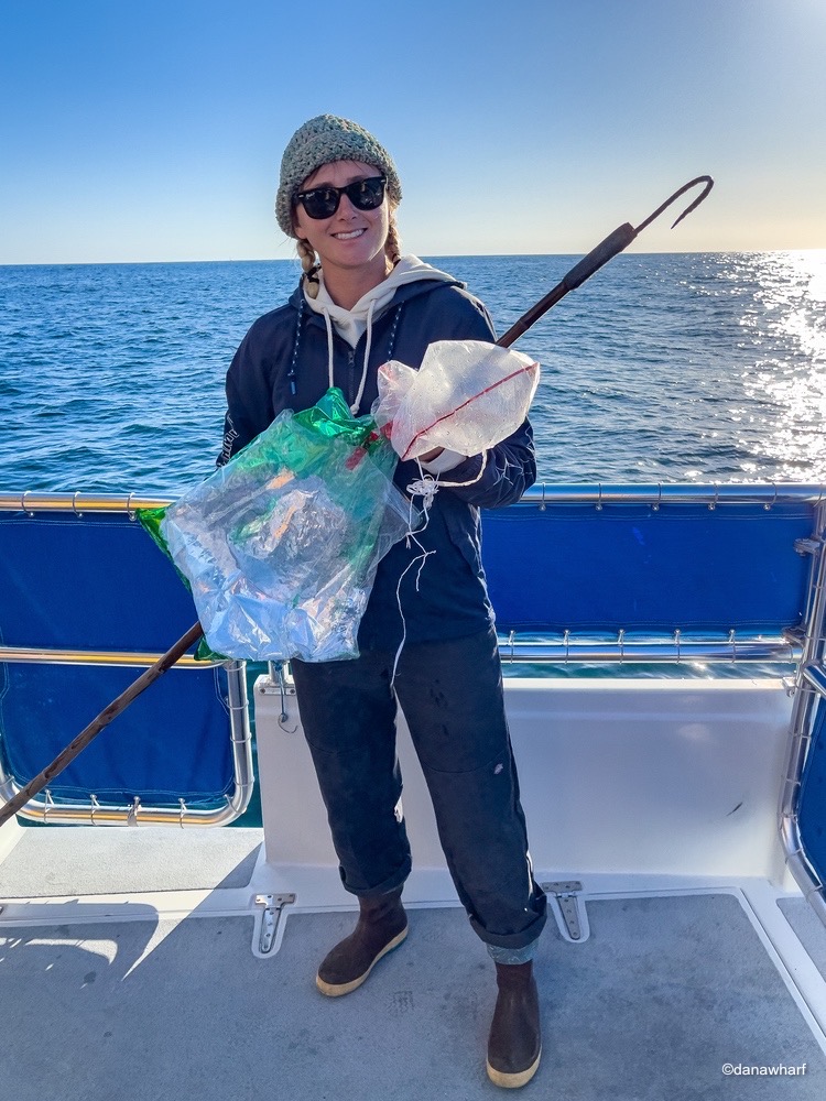 a man standing next to a body of water