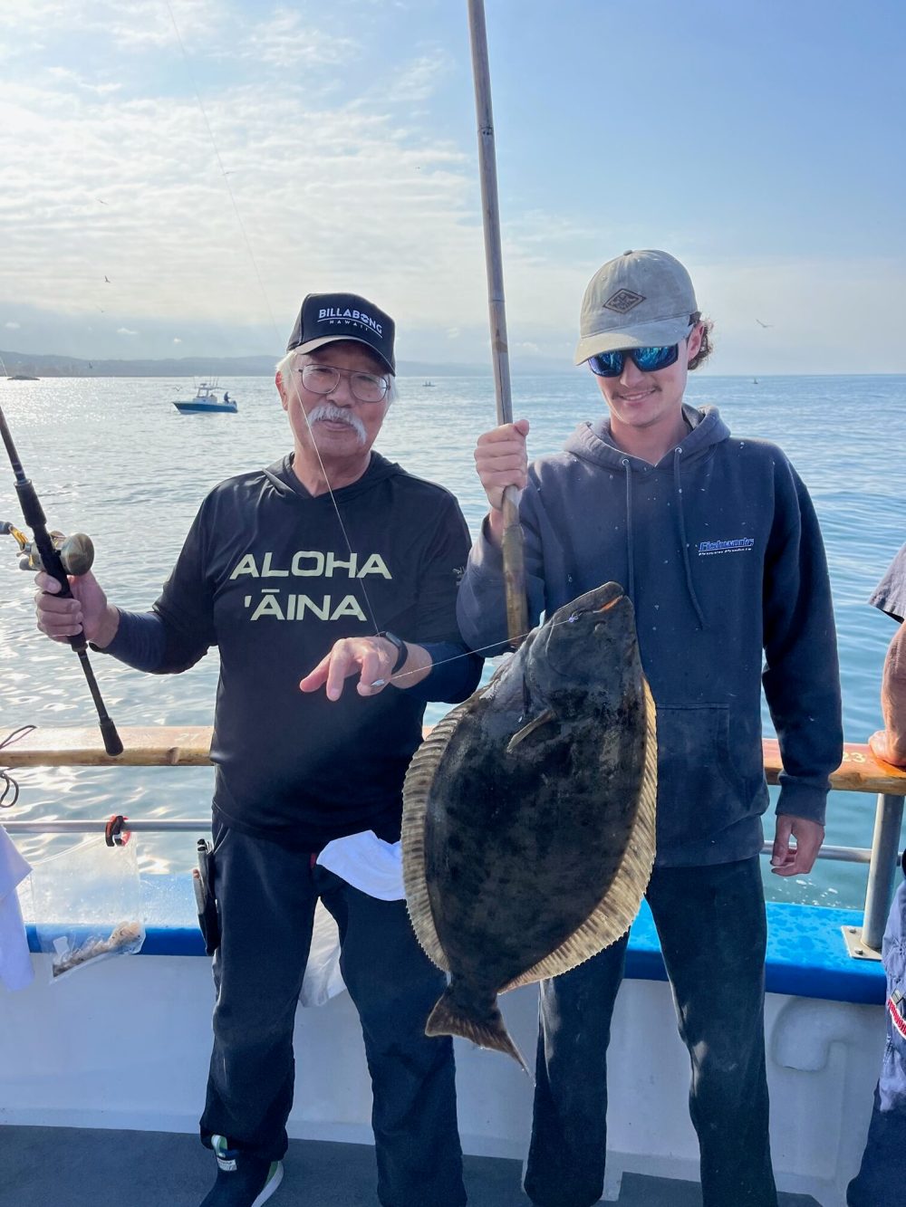 Leiji Matsumoto holding a fish in the water