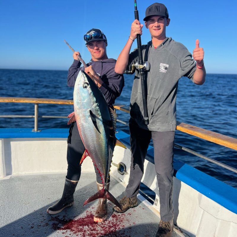 a man and a woman standing next to a body of water