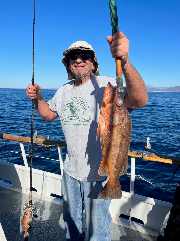 a man holding a fish in the water