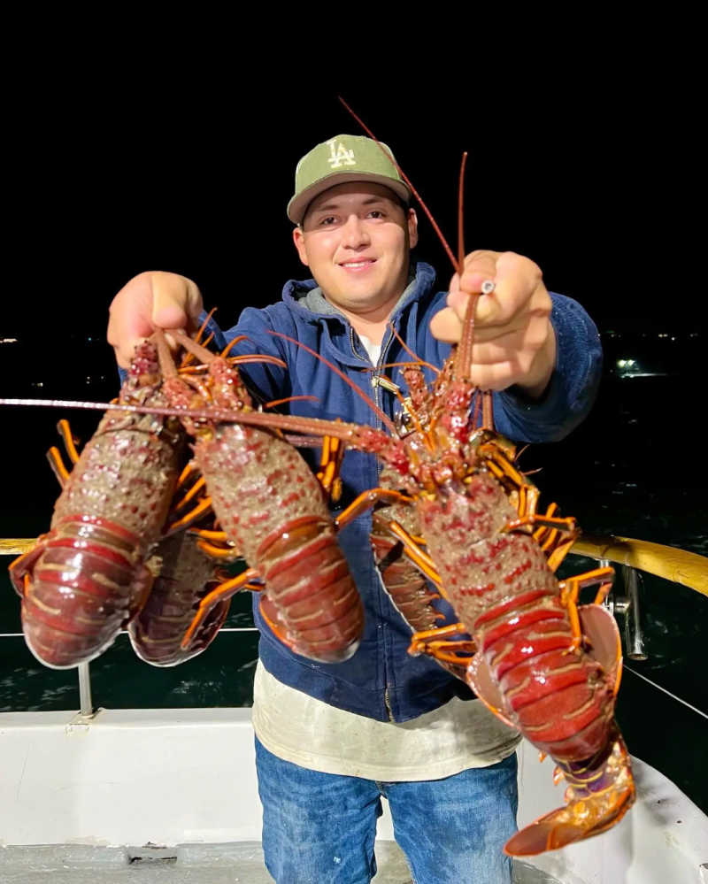 a man holding a lobster