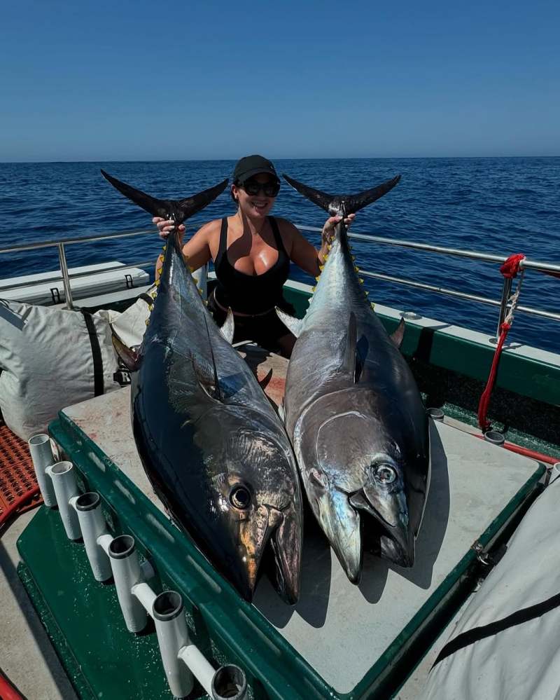a person holding a fish in the water