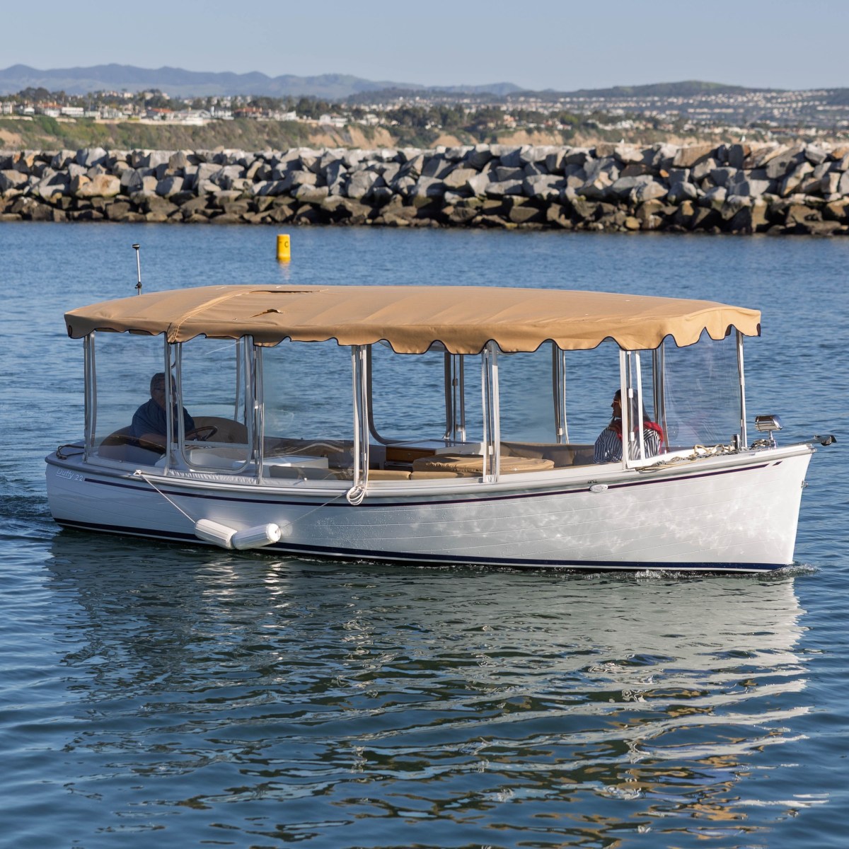 The Duffy cruising past the Dana Point Harbor breakwater