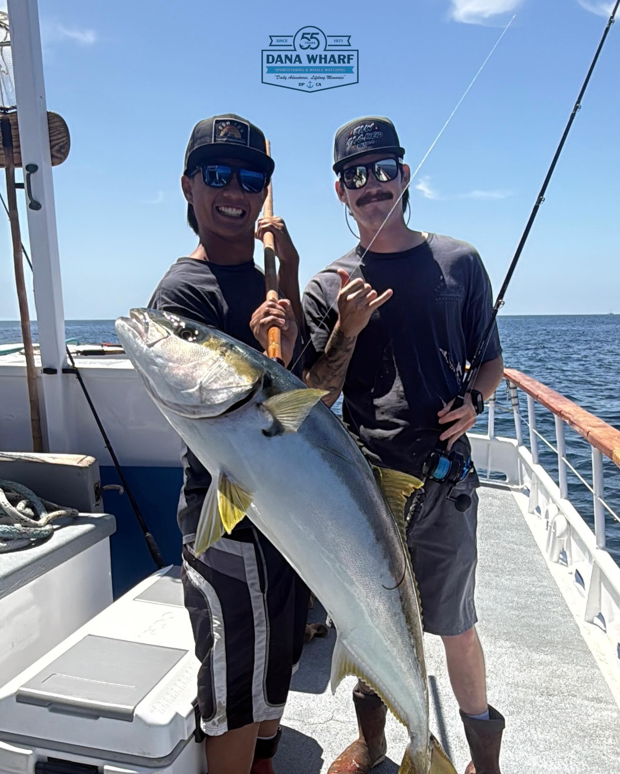 Anglers hold up a halibut caught aboard the Clemente on a half-day deep sea fishing trip out of Dana Point
