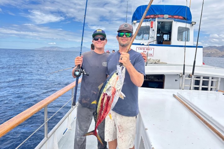 Two anglers holding a tuna on a Dana Wharf 10-hour offshore fishing trip