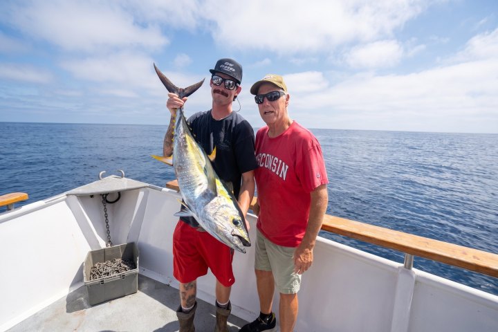 Two anglers with a tuna on a Dana Wharf 10-hour offshore fishing trip