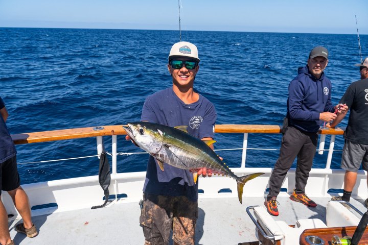 Angler with a yellowfin tuna caught on a Dana Wharf 10-hour offshore limited load trip