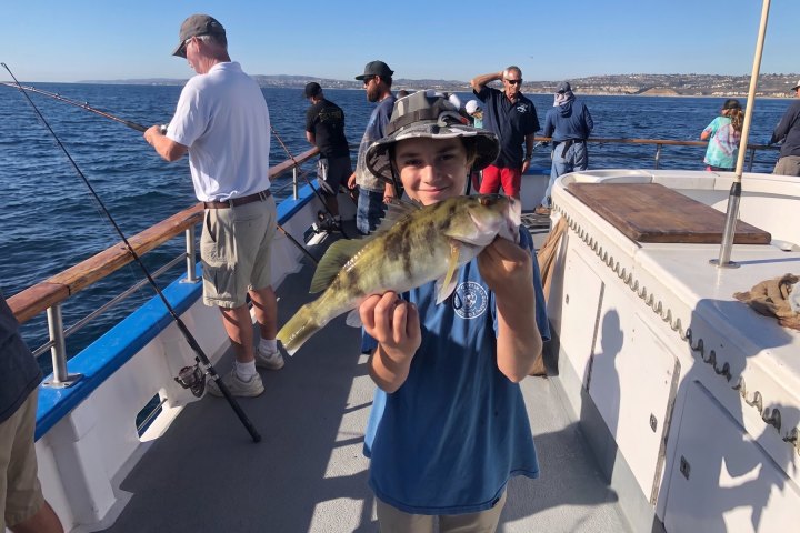 Angler with their catch on a Dana Wharf half-day fishing trip out of Dana Point