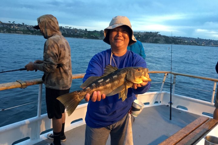 Angler with their catch on a Dana Wharf half-day fishing trip out of Dana Point