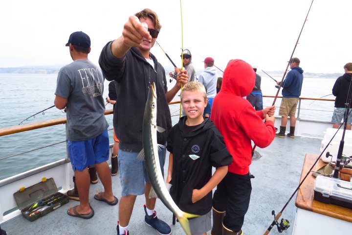 Angler with their catch on the Dana Wharf kids fishing camp out of Dana Point