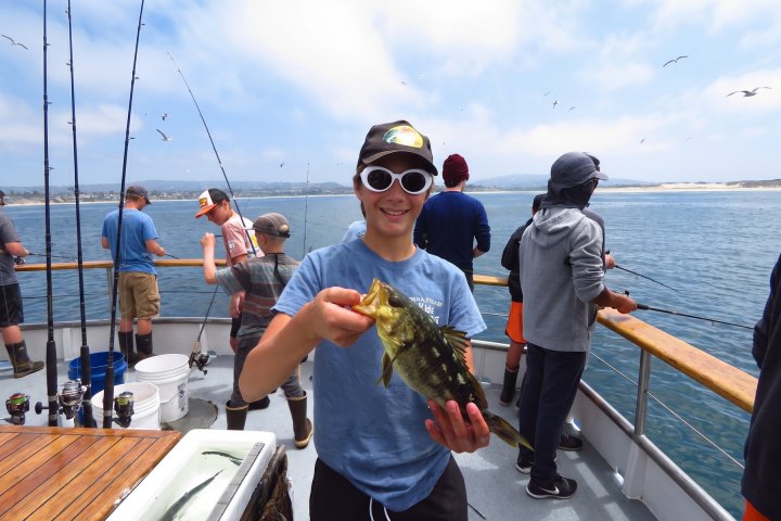 Angler with their catch on the Dana Wharf kids fishing camp out of Dana Point
