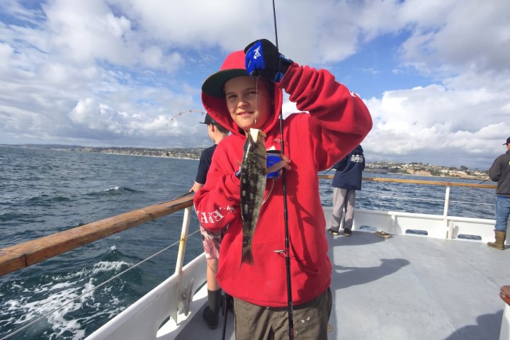 Angler with their catch on the Dana Wharf kids fishing camp out of Dana Point