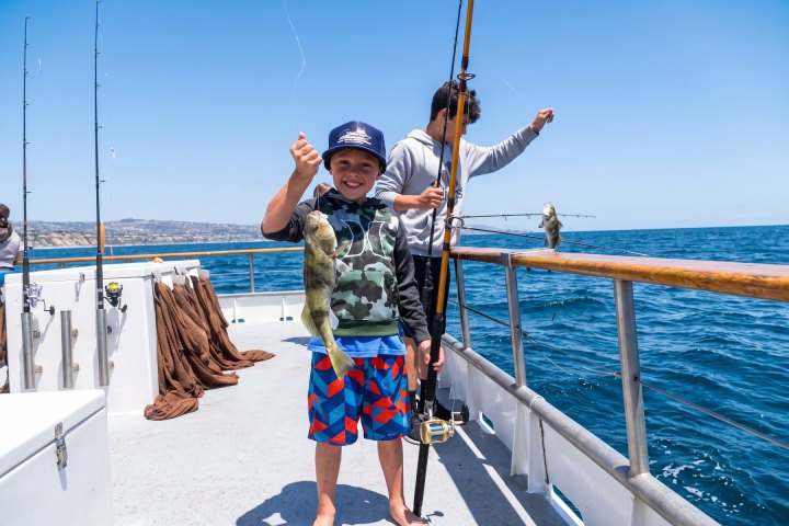 Angler with their catch on the Dana Wharf kids fishing clinic out of Dana Point