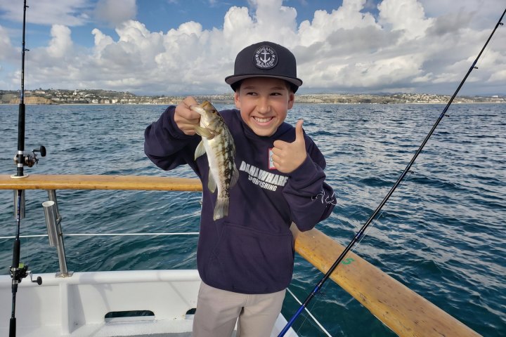 Angler with their catch on the Dana Wharf kids fishing clinic out of Dana Point