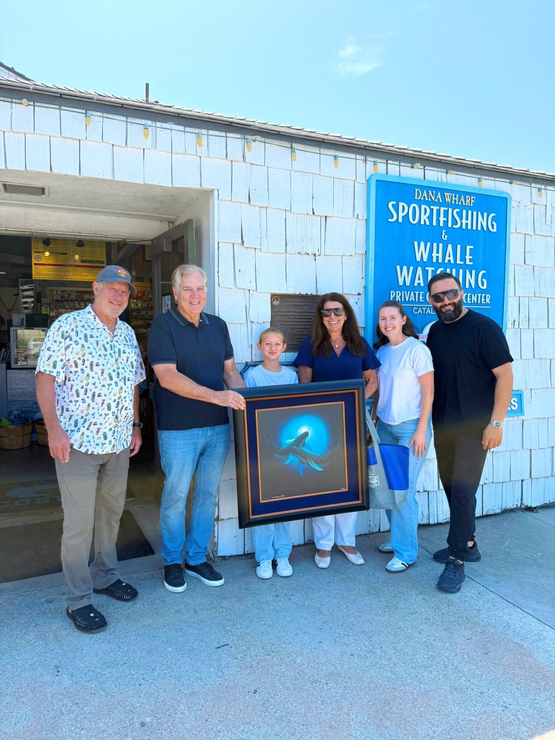 Maddie Smith receiving the 2026 Wyland Art Lessons in the Wild Grand Prize at Dana Wharf