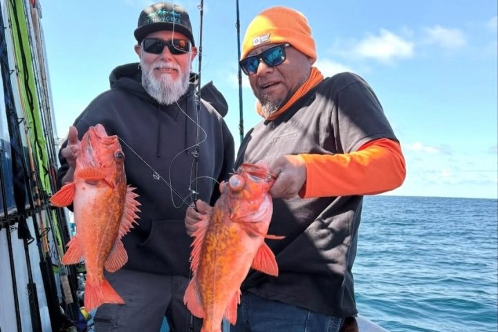 Two anglers holding rockfish on a Dana Wharf overnight fishing trip
