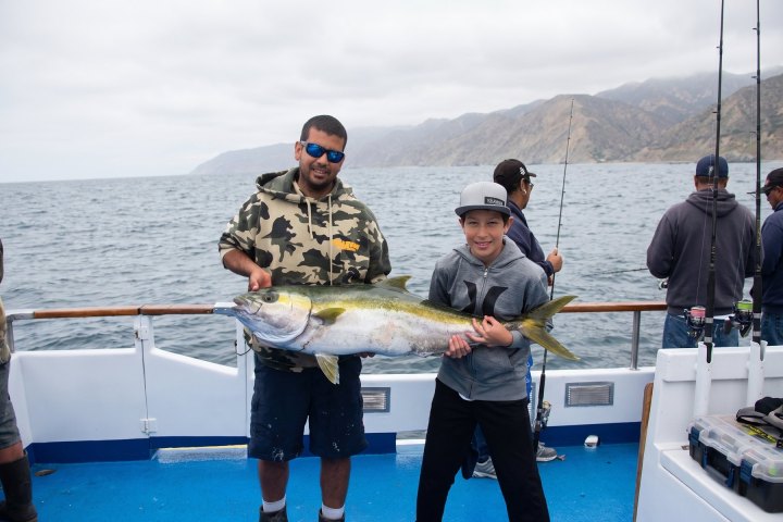 Angler with their catch on a Dana Wharf overnight fishing trip out of Dana Point